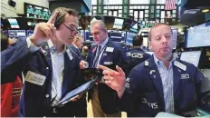  ?? AP ?? ■ Traders at the New York Stock Exchange. The S&amp;P 500 and Nasdaq posted gains for the week, while the Dow was flat.
