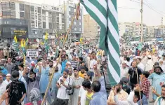  ?? REUTERS ?? Supporters of religious and political party Jamaat-e-Islami carry flags and signs to mark the ‘Day of Exploitati­on in Kashmir’.