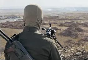  ?? RICK FINDLER/Getty Images ?? A Kurdish Peshmerga fighter is among a large number gathered in Kirkuk to defend part ofwhat they have always viewed as their homeland from the Sunni extremists.