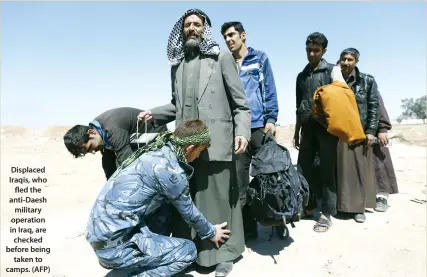  ??  ?? Displaced Iraqis, who fled the anti-Daesh military operation in Iraq, are checked before being taken to camps. (AFP)