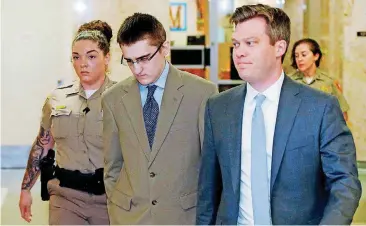  ??  ?? In this April 17 photo, Michael Bever, center, is led from a courtroom after jury selection in his trial in Tulsa. At right is his defense attorney Corbin Brewster. Bever, the younger of two brothers accused of fatally stabbing their parents and three...