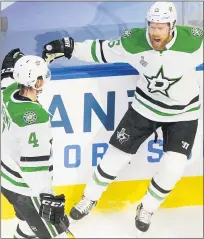  ?? JASON FRANSON— THE ASSOCIATED PRESS ?? Dallas Stars’ Joe Pavelski, left, celebrates his goal against the Tampa Bay Lightning with teammate Miro Heiskanen during the Stars’ overtime win in Game 5of the Stanley Finals on Saturday.