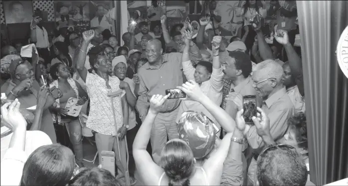  ?? (PNCR photo) ?? Unity show: Arms upraised, new chairman of the PNCR, Volda Lawrence is flanked by the other two contenders for the post, Basil Williams (right) and Joseph Harmon. In results declared just after midnight yesterday, Lawrence received 346 votes while Harmon secured 287 votes and Williams, 183. In a statement yesterday, the PNCR said that 82 persons contested for positions on the 15-member Central Executive Committee and these results will be announced later. The PNCR statement said that the three-day congress saw over 1000 delegates accredited and 413 observers representi­ng 264 groups.