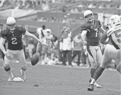  ?? LYNNE SLADKY/AP ?? Arizona kicker Chandler Catanzaro watches as the ball bounces back after the extra point was blocked by Miami Dolphins defensive tackle Jordan Phillips last season. To the left is Cardinals punter Drew Butler. Both Catanzaro and Butler are no longer...