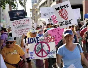  ?? PHOTO/MATT YORK ?? People protest outside the Phoenix Convention Center on Tuesday in Phoenix. Protests were held against President Donald Trump as he hosted a rally inside the convention center. AP