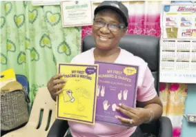  ?? ?? Principal May Pinnock-mitchell with the book she has written.