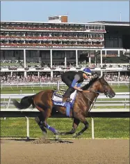  ?? Mel Evans / Associated Press ?? Fans watch as Triple Crown winner American Pharoah with Jorge Alvarez up trains at Monmouth Park in Oceanport, N.J., in July 2015.