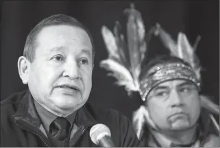  ?? The Canadian Press ?? Grand Chief Stewart Phillip, left, president of the Union of B.C. Indian Chiefs, speaks as William George, a member of the Tsleil-Waututh First Nation and a guardian at the watch house near Kinder Morgan’s Burnaby facility, listens during a news...