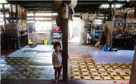  ??  ?? What about me?
several families.
What’s in her future? This little Long Lamai village girl lives in a typical longhouse community comprising