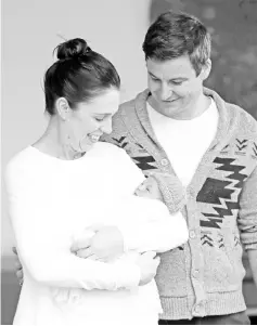  ?? — AFP photo ?? Ardern and partner Clarke Gayford pose with Neve outside the hospital in Auckland.