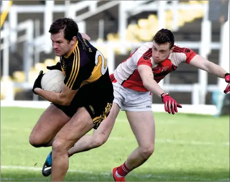  ??  ?? Eoin Brosnan, Dr Crokes slips past Shane Ryan, Rathmore in the East Kerry O’Donoghue Cup semi-final at Fitzgerald Stadium, Killarney on Sunday Photo by Michelle Cooper Galvin