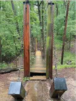 ?? The Sentinel-record/corbet Deary ?? ■ Those taking a walk along Falls Branch Trail will have the opportunit­y to experience walking across a swinging bridge.