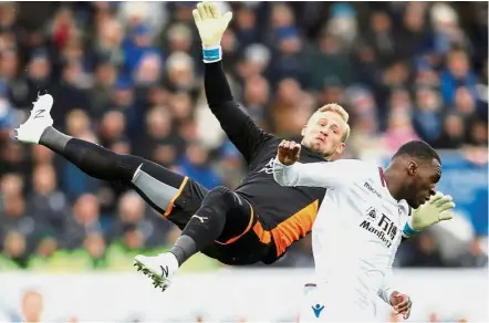  ?? — Reuters ?? C-r-a-s-h: Crystal Palace’s Christian Benteke colliding with Leicester goalkeeper Kasper Schmeichel at the King Power Stadium on Saturday.