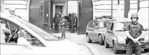  ?? — AFP photos ?? File photo shows policemen standing guard as a convoy arrives at Paris’ courthouse prior to a hearing of Abdelkader Merah.