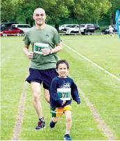  ?? ?? Father Moss Page and son Enzo are all smiles as they complete the 2.5k.