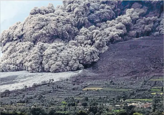  ?? Photo: REUTERS ?? Force of nature: A huge ash cloud spews from Mt Sinabung and rolls towards the village of Berastepu.