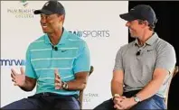  ?? Wilfredo Lee / Associated Press ?? Golfers Tiger Woods and Rory Mcilroy discuss on Tuesday the future home of their tech-infused golf league that will begin play next year in Palm Beach Gardens, Fla.