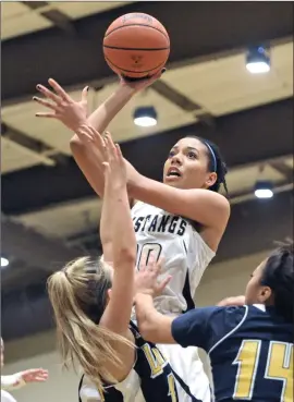  ?? Dan Watson/ The Signal (See additional photos on signalscv.com) ?? The Master’s College’s Chayan Lowery, top, shoots against La Sierra University during Thursday’s game at TMC. Lowery scored nine points and tallied eight rebounds.