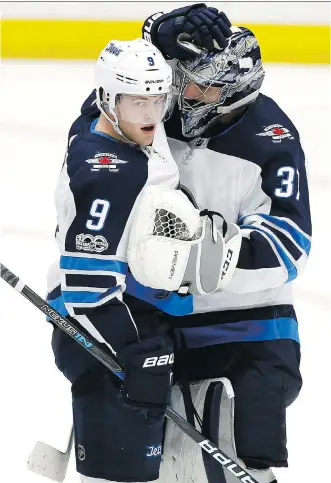  ?? ALEX GALLARDO/THE ASSOCIATED PRESS ?? Winnipeg Jets centre Andrew Copp celebrates with Connor Hellebuyck after Friday’s win over the Anaheim Ducks in Anaheim, Calif. The game was the third of a four-game road trip.