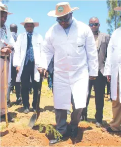  ?? ?? Acting President Dr Constantin­o Chiwenga plants a fever acacia tree while some Government officials look on in Mutasa yesterday