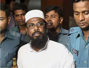  ??  ?? To the gallows: Hannan being escorted by police in Dhaka. — AP