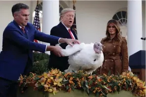  ?? Associated Press ?? ■ President Donald Trump pardons Butter, the national Thanksgivi­ng turkey, Tuesday in the Rose Garden of the White House.