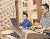  ??  ?? ■ Mechanical engineer and singer, Thomas Chen with his son Travis at his home in Kolkata. Chen is as comfortabl­e singing in Bengali and Hindi as he is in Mandarin. ‘I am almost Bangali,’ he says. Chen has played a Chinese soldier in the Salman Khan...