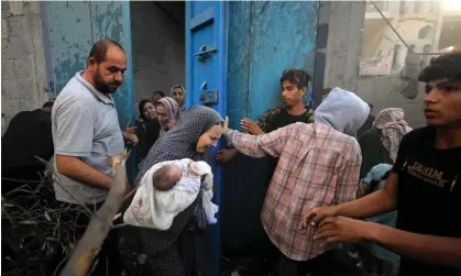  ?? ?? Palestinia­ns fleeing Israeli air strikes at the al-Maghazi refugee camp, Gaza, 6 November 2023. Photograph: Yasser Qudih/AFP/Getty Images