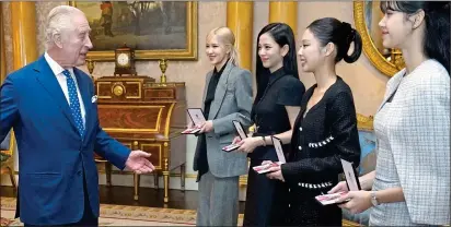  ?? ?? awarded: Members of Blackpink receive MBEs from the UK’s King Charles at Buckingham Palace last week