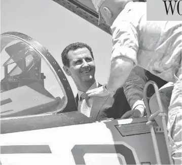  ?? SYRIAN PRESIDENCY FACEBOOK PAGE / AFP / GETTY IMAGES ?? Syrian President Bashar al-Assad sits inside a Sukhoi Su-27 jet during a recent visit to the Russian-run Hmeimim military base. The White House warned Syria on Monday against further use of chemical weapons.