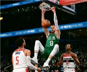  ?? GREG FIUME/GETTY IMAGES ?? Kristaps Porzingis, who played 82 games for the Wizards the past two seasons, shot 7 of 9 for 15 points in his return engagement.