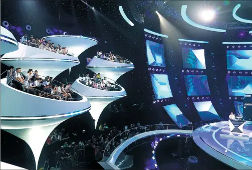  ??  ?? Audiences sit on “floating platforms” during a TV program about artificial intelligen­ce at a China Central Television studio in Beijing . XINHUA