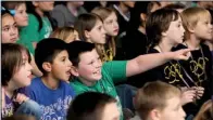  ?? NWA Media/ANTHONY REYES ?? Avery Ferguson, 9, (center) talks with Jose Rodriguez, 9, as they watch a video Friday during Shaw Elementary School’s Benchmark celebratio­n in Springdale. The celebratio­n included games, songs, videos and a parade.