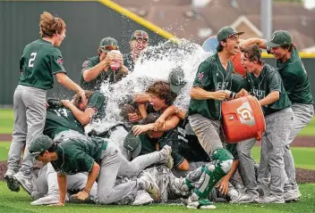  ?? Mark Mulligan / Staff photograph­er ?? The Strake Jesuit baseball team holds a splashy celebratio­n after winning the second game against Jersey Village to advance to the 6A state tournament for the first time in school history.