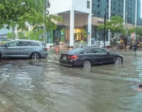  ?? PEDRO PORTAL/MIAMI HERALD VIA AP ?? Tropical Storm Alex leaves 11 inches of rain and floods the Brickell area near downtown Miami on Saturday.