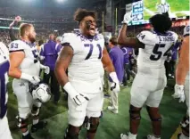  ?? AP PHOTO/ROSS D. FRANKLIN ?? TCU offensive tackle Marcus Williams (71) celebrates with teammates after the defeating Michigan in Fiesta Bowl, a College Football Playoff semifinal on Dec. 31.