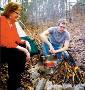  ?? PHOTOS BY KEITH SUTTON/CONTRIBUTI­NG PHOTOGRAPH­ER ?? Although the reflector oven isn’t used as often as it once was, it’s a great culinary tool that allows camp chefs like Theresa and Zach Sutton of Alexander to bake delicious foods quickly and easily.