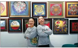  ?? PHOTOS BY ZOU HONG / CHINA DAILY ?? Left: Guan Dian and her husband, Li Jinglong, run cloisonne workshops in Beijing. Right: Guan instructs a student on how to create a painting. The fish image involves soldering delicate metal strips bent to the outline of a design and filling the spaces with different colors.