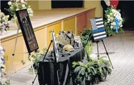  ?? MARIA LORENZINO/STAFF PHOTOGRAPH­ER ?? Delray Beach Officer Christine Braswell’s uniform and equipment sit on a table during her funeral service on Sunday.