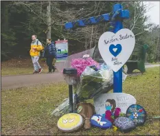  ??  ?? A tribute to Kristen Beaton and her unborn child is part of a memorial walk for mass-shooting victims in Truro, N.S.