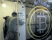  ?? KIN CHEUNG/THE ASSOCIATED PRESS ?? Above: People use a Bitcoin ATM in Hong Kong. The launch of a U.S. futures contract for bitcoin on Sunday, Dec. 10, 2017, underscore­s the virtual currency’s increasing mainstream acceptance. Financial experts say the soaring value of the digital...
