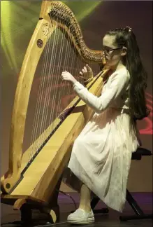  ??  ?? Úna Walsh from Taghmon playing ‘Postman’s Lament’ and ‘Kings of Kerry (slide)’ on the harp.