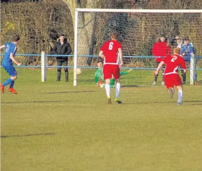  ??  ?? Llantwit Major goalkeeper Jack Landsdown saves a penalty from Garin Withers
