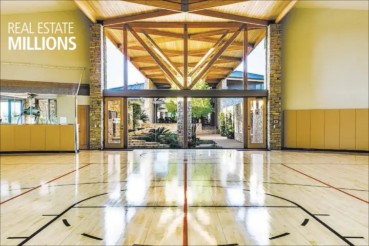  ?? COURTESY LUXURY ESTATES INTERNATIO­NAL ?? The indoor sports court in this 17,000-square-foot home featured hardwood floors, surround sound speakers, glass wall protection for spectators and electronic hoops that adjust to any height.