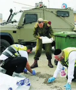  ?? AP ?? Las autoridade­s israelíes limpian la sangre en Ariel, ayer