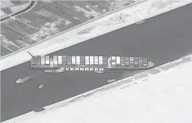  ?? CNES2021, DISTRIBUTI­ON AIRBUS DS ?? This satellite image shows the massive cargo ship Ever Given stuck Thursday in the Suez Canal. Now the business of determinin­g who will pay for clearing the vessel from the key shipping lane begins. The results may not be known for several years.