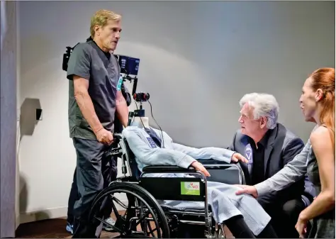  ??  ?? Randal Kleiser pushing the wheelchair in which the VR camera, Nokia OZO, is placed on the head of a robot.