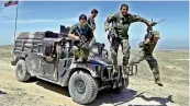  ?? — AP ?? Afghan commandos arrive at a village near the site of the US bombing in Jalalabad, east of Kabul