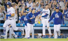  ?? THE ASSOCIATED PRESS ?? It’s been that kind of season for the L.A. Dodgers, seen celebratin­g a ninthinnin­g victory over the Chicago White Sox last week, one of 90 wins the club had registered heading into Friday night.