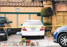  ?? Dania Maxwell Los Angeles Times ?? A MEMORIAL outside the Riverside home where a Virginia police officer killed the grandparen­ts and mother of a teenage girl he “catfished” online.